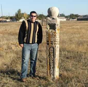 Ruslan beside 19C grave stone Karachaganak Village, Kazakhstan, 2007