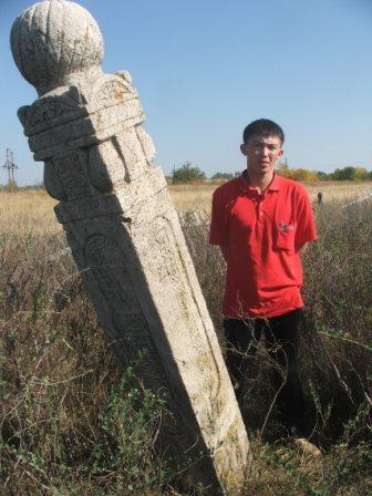 Talgat beside grave marker Karchaganak Village, Kazakhanstan, 2007